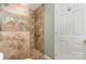 A well-designed bathroom showcasing textured tile shower, grab bars, and coordinated tile accents at 1026 Eagles Nest Ln, Fort Mill, SC 29707