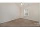 This is a bedroom with neutral walls, beige carpet, a window, and blinds at 1026 Eagles Nest Ln, Fort Mill, SC 29707