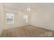 Neutral bedroom with natural light from two windows and a ceiling fan at 1026 Eagles Nest Ln, Fort Mill, SC 29707