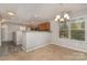Bright dining area with modern chandelier, large window, and a view of the kitchen area at 1026 Eagles Nest Ln, Fort Mill, SC 29707