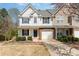 Attractive townhome with a well-kept lawn, complemented by vibrant flowers and mature landscaping at 1026 Eagles Nest Ln, Fort Mill, SC 29707