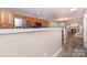 View of an open-concept kitchen with stainless steel appliances overlooking the living room and stairway at 1026 Eagles Nest Ln, Fort Mill, SC 29707