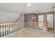 A loft featuring a ceiling fan and overlooking the living room with a fireplace at 1026 Eagles Nest Ln, Fort Mill, SC 29707