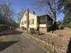 Charming home with yellow siding, mature trees, and a lovely yard at 1109 West Blvd, Charlotte, NC 28208