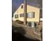 Close up of exterior showing yellow siding, brick accents, and a well-maintained yard at 1109 West Blvd, Charlotte, NC 28208