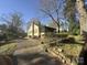 Charming home with yellow siding, mature trees, and a lovely yard at 1109 West Blvd, Charlotte, NC 28208