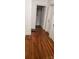 Hallway with gleaming hardwood floors leading to rooms with doors and trim at 1109 West Blvd, Charlotte, NC 28208