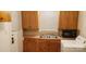 Functional laundry area featuring wood cabinets, sink, and modern appliances for convenience at 1109 West Blvd, Charlotte, NC 28208