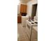 Functional laundry area featuring wood cabinets, sink, and modern appliances at 1109 West Blvd, Charlotte, NC 28208
