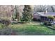 Beautiful backyard with mature trees, brick home exterior, and lush landscaping at 116 Jonas Dr, Lincolnton, NC 28092