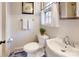 Cozy bathroom with paneled walls, toilet, and vintage sink and fixtures at 116 Jonas Dr, Lincolnton, NC 28092