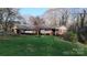 Charming brick home nestled amongst trees and a spacious front lawn at 116 Jonas Dr, Lincolnton, NC 28092