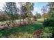 Expansive backyard with manicured lawn, mature trees, and established landscaping at 124 Gatlin Knl # 11, New London, NC 28127