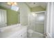 Bright bathroom featuring a skylight, glass-door shower, and white vanity at 124 Gatlin Knl # 11, New London, NC 28127