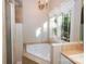 A bathtub is encased in tile and is beneath a window for a naturally lit bathroom at 124 Gatlin Knl # 11, New London, NC 28127