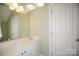 Bright bathroom features a white vanity with drawers, sink, and large mirror at 124 Gatlin Knl # 11, New London, NC 28127