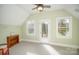 Spacious bedroom boasts natural light and vaulted ceilings, complemented by a ceiling fan at 124 Gatlin Knl # 11, New London, NC 28127