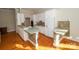 Well-appointed kitchen features white cabinetry, tile countertops, and hardwood floors with modern appliances at 124 Gatlin Knl # 11, New London, NC 28127