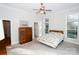 Spacious main bedroom with wood dresser, bright windows, and neutral colored carpet at 124 Gatlin Knl # 11, New London, NC 28127