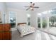 The bright main bedroom features lots of windows, access to the sunroom, and a ceiling fan at 124 Gatlin Knl # 11, New London, NC 28127