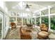 The sunroom is encased in windows and features wicker furniture and brick floors at 124 Gatlin Knl # 11, New London, NC 28127