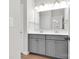 Modern bathroom featuring double sink vanity with gray cabinets, large mirror and modern fixtures at 1501 Allegheny Way, Waxhaw, NC 28173