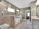 Bathroom featuring a bathtub, glass shower, and large mirror at 1501 Allegheny Way, Waxhaw, NC 28173