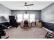 This bedroom boasts carpet floors, a ceiling fan, and ample natural light from the three large windows at 1501 Allegheny Way, Waxhaw, NC 28173