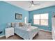 Bright bedroom with blue walls, carpet floors, ceiling fan, a window, and cozy decor at 1501 Allegheny Way, Waxhaw, NC 28173