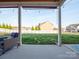 Covered patio area overlooking the backyard, offering shade and a peaceful outdoor space at 1501 Allegheny Way, Waxhaw, NC 28173