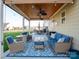 Inviting covered patio featuring comfortable seating, ceiling fans, and decorative lighting for outdoor enjoyment at 1501 Allegheny Way, Waxhaw, NC 28173