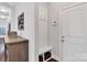 Inviting entryway with mudroom bench, coat hooks, and wood-look storage unit at 1501 Allegheny Way, Waxhaw, NC 28173
