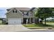 Charming two-story home with a well-manicured lawn and inviting curb appeal with attached garage at 1501 Allegheny Way, Waxhaw, NC 28173