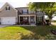 Charming two-story home with a well-manicured lawn and inviting front porch at 1501 Allegheny Way, Waxhaw, NC 28173