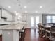 Bright, open kitchen featuring a large island, stainless steel appliances, and a seamless connection to dining area at 1501 Allegheny Way, Waxhaw, NC 28173
