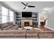 Cozy living room featuring a brick fireplace with built-in shelving at 1501 Allegheny Way, Waxhaw, NC 28173
