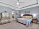 This primary bedroom features carpet floors, a ceiling fan, and a large dresser with ample space at 1501 Allegheny Way, Waxhaw, NC 28173