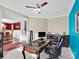 Well-lit office featuring a dark wood desk, blue accent wall, and adjacent dining room at 1501 Allegheny Way, Waxhaw, NC 28173