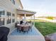 Outdoor dining on covered patio with BBQ, seating, and lush green yard beyond at 1501 Allegheny Way, Waxhaw, NC 28173
