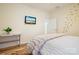 Bright bedroom with light walls, decorative butterflies, and a wall-mounted television at 15115 Rocky Bluff Loop, Davidson, NC 28036