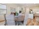 The dining area features a round wooden table with cushioned seating, and a kitchen with white cabinets at 15115 Rocky Bluff Loop, Davidson, NC 28036