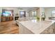 Open-concept kitchen with quartz countertop island and seamless view to the living room at 15115 Rocky Bluff Loop, Davidson, NC 28036