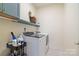 Efficient laundry room with modern washer and dryer, storage, and organized supplies at 15115 Rocky Bluff Loop, Davidson, NC 28036
