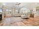 Bright living room with large windows, fireplace, ceiling fan, and hardwood floors at 15115 Rocky Bluff Loop, Davidson, NC 28036
