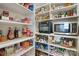 Well-stocked pantry featuring organized shelving and a variety of food items at 15115 Rocky Bluff Loop, Davidson, NC 28036