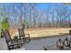 Inviting outdoor patio with rocking chairs and serene backyard views at 15115 Rocky Bluff Loop, Davidson, NC 28036