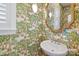 Charming powder room with unique palm wallpaper, window, and white pedestal sink at 15115 Rocky Bluff Loop, Davidson, NC 28036