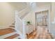 Open staircase with white railing and hardwood floors, leading to the upper level at 15115 Rocky Bluff Loop, Davidson, NC 28036