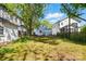 Backyard view with grass and trees and the back of neighboring homes at 1631 Fulton Ave, Charlotte, NC 28205
