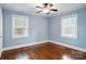 Bedroom featuring hardwood floors, ceiling fan and natural light from two windows at 1631 Fulton Ave, Charlotte, NC 28205